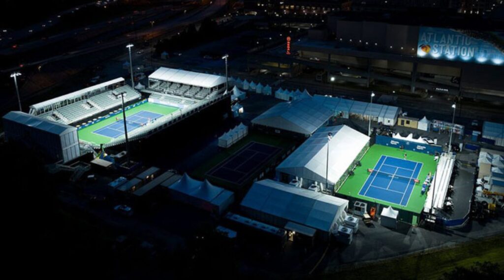 an aerial view of a tennis stadium at night