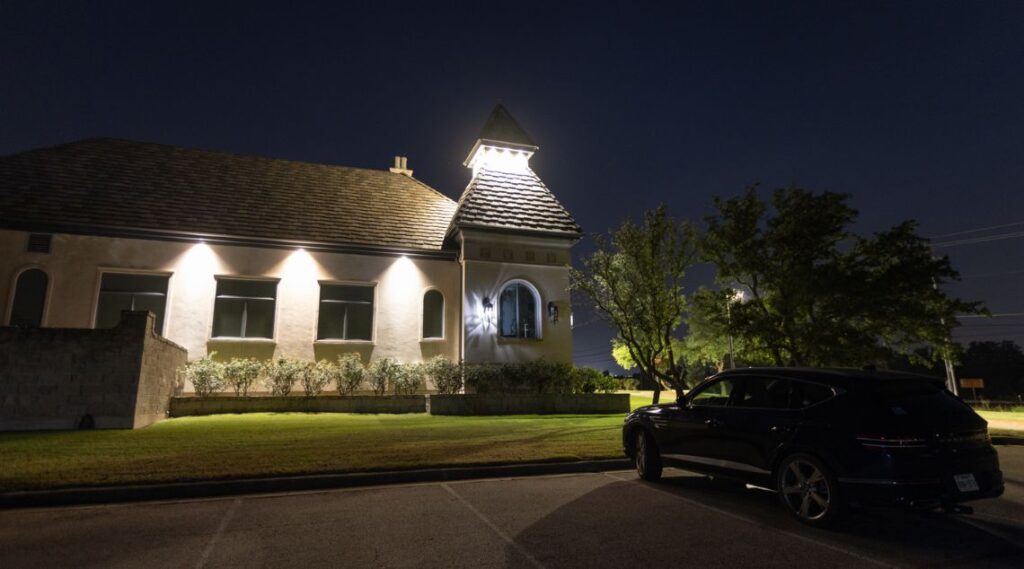 a car parked in front of a church at night